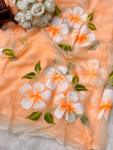 Hand-painted chiffon saree with large floral motifs in pastel shades β lightweight, flowy, and elegant.