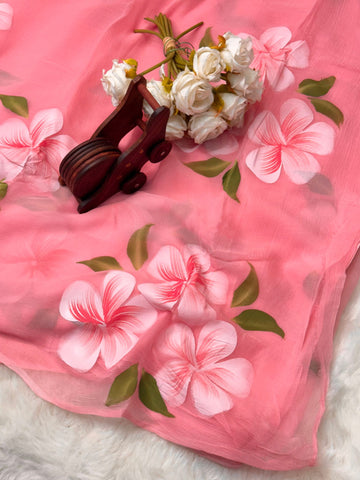 Hand-painted chiffon saree with large floral motifs in pastel shades β lightweight, flowy, and elegant.