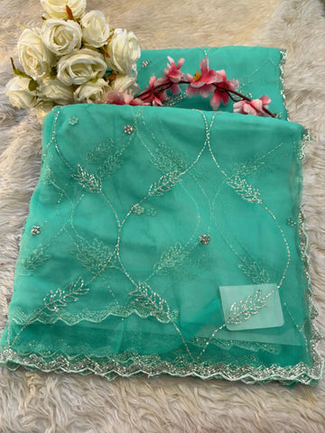 Net saree with floral sequin embroidery, leaf vine motifs, and zigzag border work β includes unstitched blouse