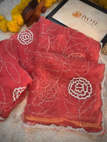 Glass tissue saree with floral embroidery in cutdana and pearl work, scalloped border, and unstitched blouse piece β by Jyoti Sarees