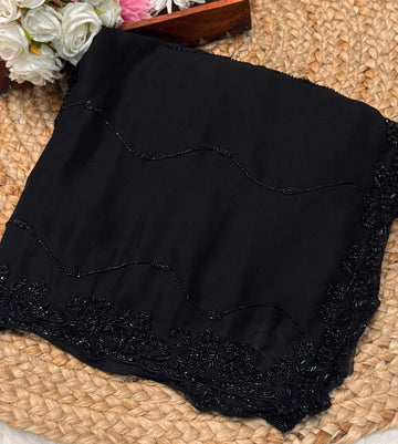 Black Rangoli silk saree with wave-style cutdana embroidery β folded view