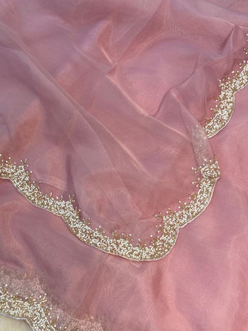 Organza saree featuring delicate scalloped pearl beadwork border with matching unstitched heavy blouse embellished in intricate pearl detailing – ideal for festive and wedding wear.