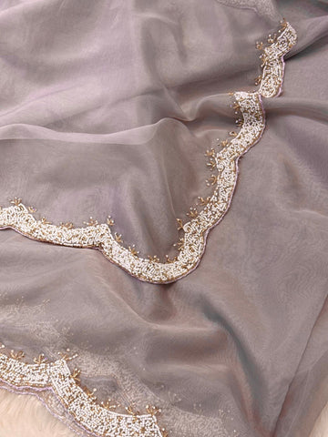 Organza saree featuring delicate scalloped pearl beadwork border with matching unstitched heavy blouse embellished in intricate pearl detailing – ideal for festive and wedding wear.