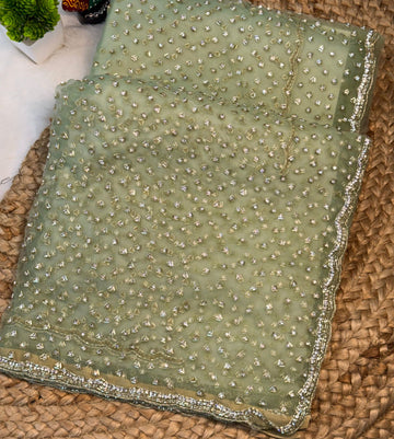 Glass tissue saree with intricate silver samosa handwork and scalloped sequin border, available in elegant pastel and jewel-tone shades