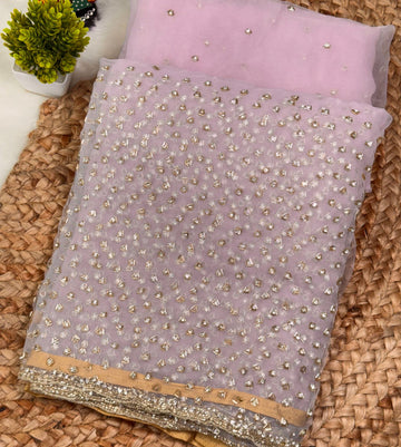 Glass tissue saree with intricate silver samosa handwork and scalloped sequin border, available in elegant pastel and jewel-tone shades