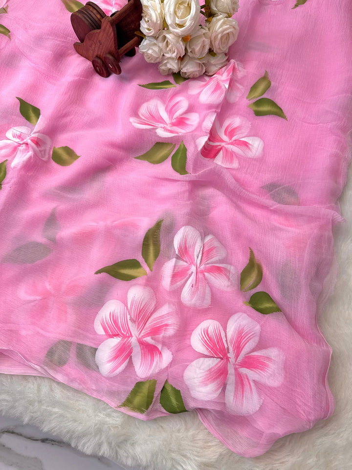 Hand-painted chiffon saree with large floral motifs in pastel shades – lightweight, flowy, and elegant.

