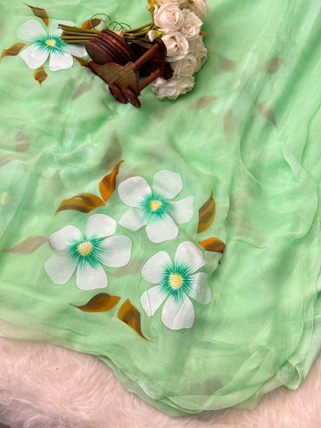 Hand-painted chiffon saree with large floral motifs in pastel shades – lightweight, flowy, and elegant.

