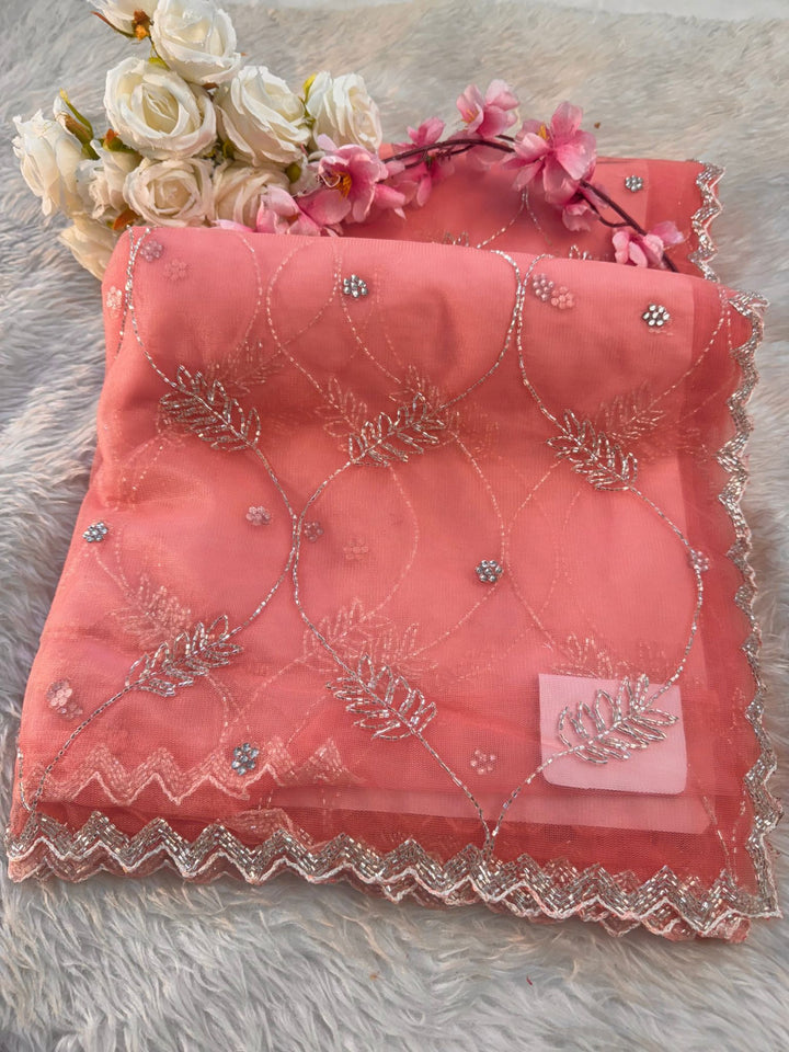 Net saree with floral sequin embroidery, leaf vine motifs, and zigzag border work – includes unstitched blouse