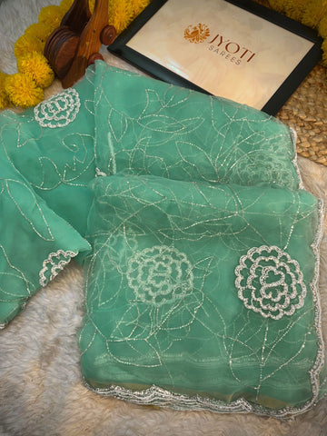 Glass tissue saree with floral embroidery in cutdana and pearl work, scalloped border, and unstitched blouse piece – by Jyoti Sarees