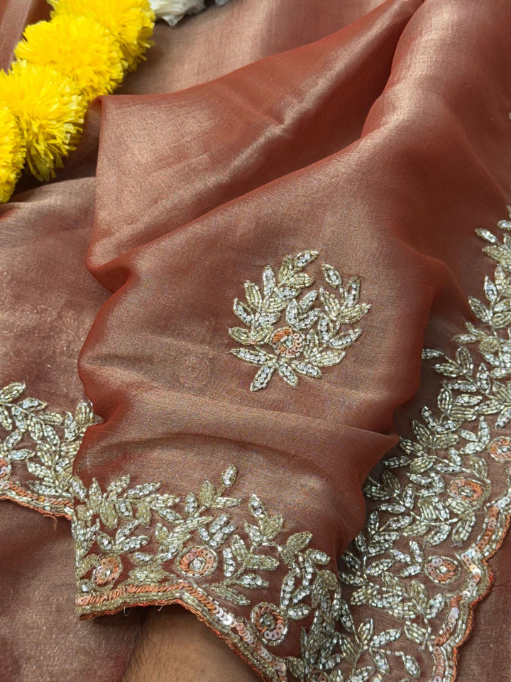
Indian Lady Tissue saree with heavy cutdana handwork, sequin floral motifs, and scalloped embroidered border