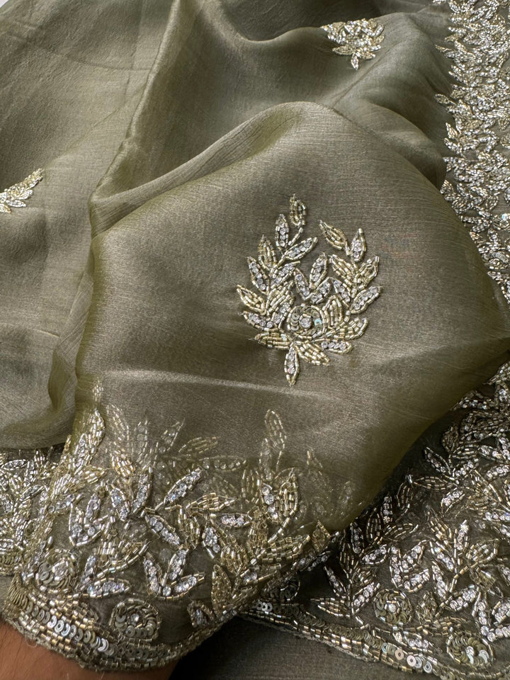 
Indian Lady Tissue saree with heavy cutdana handwork, sequin floral motifs, and scalloped embroidered border
