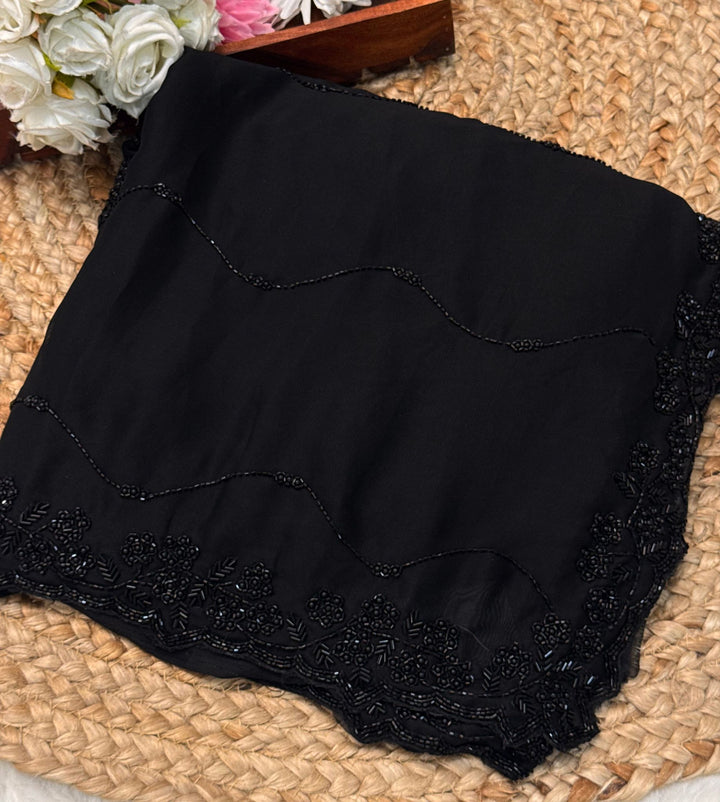 Black Rangoli silk saree with wave-style cutdana embroidery – folded view