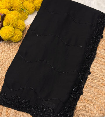 Black Rangoli silk saree with wave-style cutdana embroidery – folded view