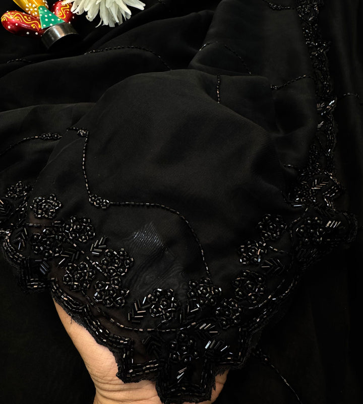 Black Rangoli silk saree with wave-style cutdana embroidery – folded view