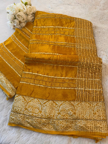 Premium HO Silk Saree with golden zari border, sequin stripes, and matching blouse piece – available in mustard, green, purple, turquoise, and red.