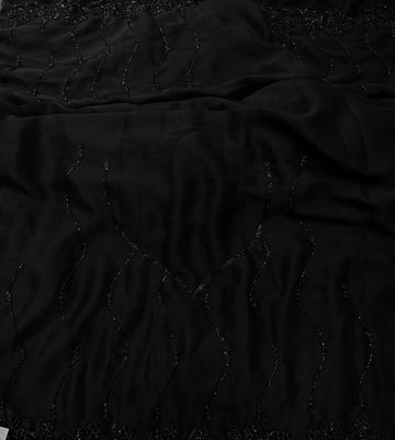 Black Rangoli silk saree with wave-style cutdana embroidery – folded view