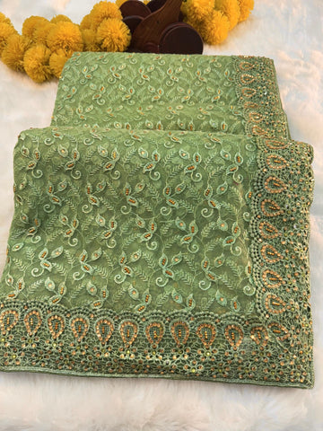 "Elegant net saree with intricate jaal embroidery and embellished border, paired with matching unstitched blouse – perfect for festive and wedding wear