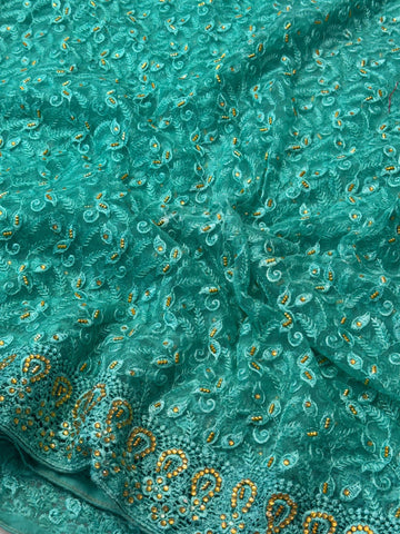 "Elegant net saree with intricate jaal embroidery and embellished border, paired with matching unstitched blouse – perfect for festive and wedding wear