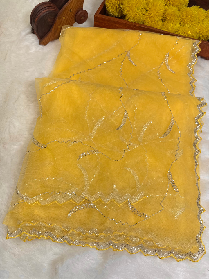 Designer net saree with abstract scalloped sequin embroidery, available in red, yellow, and sky blue – with matching blouse from Jyoti Sarees