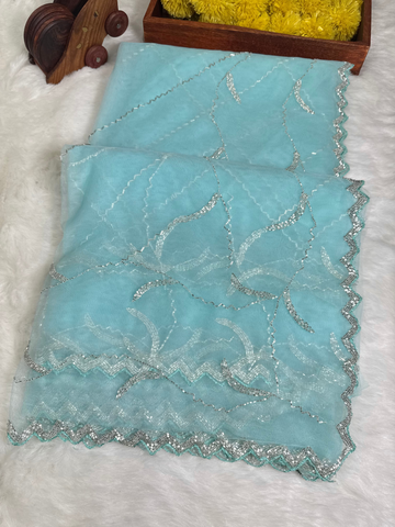 Designer net saree with abstract scalloped sequin embroidery, available in red, yellow, and sky blue – with matching blouse from Jyoti Sarees