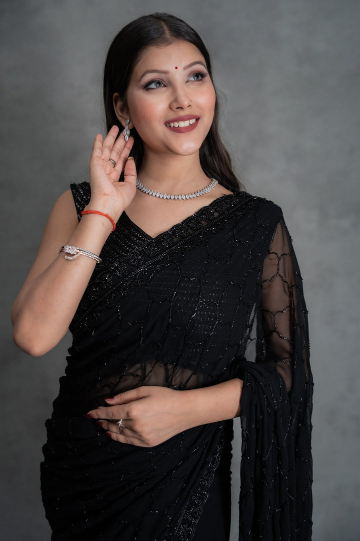 Black georgette saree with all-over cutdana embroidery – folded view