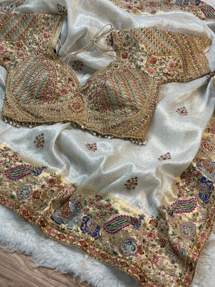 Ivory Jacquard Silk Saree with Royal Peacock & Elephant Embroidered Border (Stitched Blouse)